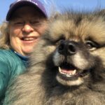 Cat Malkin seated with her beloved dog Bodhi Bear in California, sharing a quiet moment together.